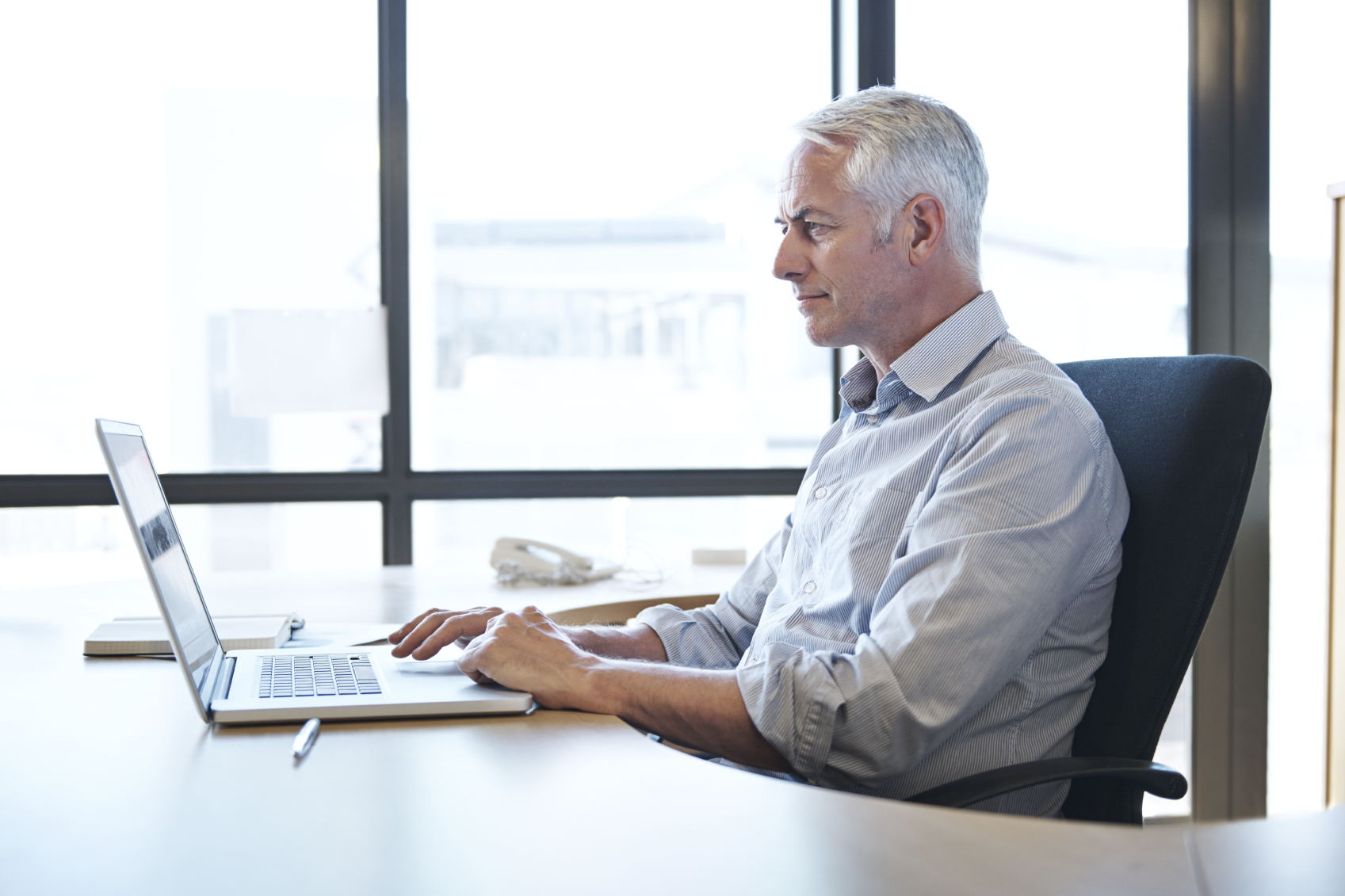 older man using computer