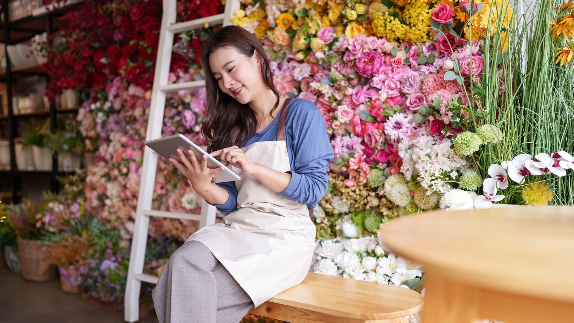 flower shop worker using a tablet