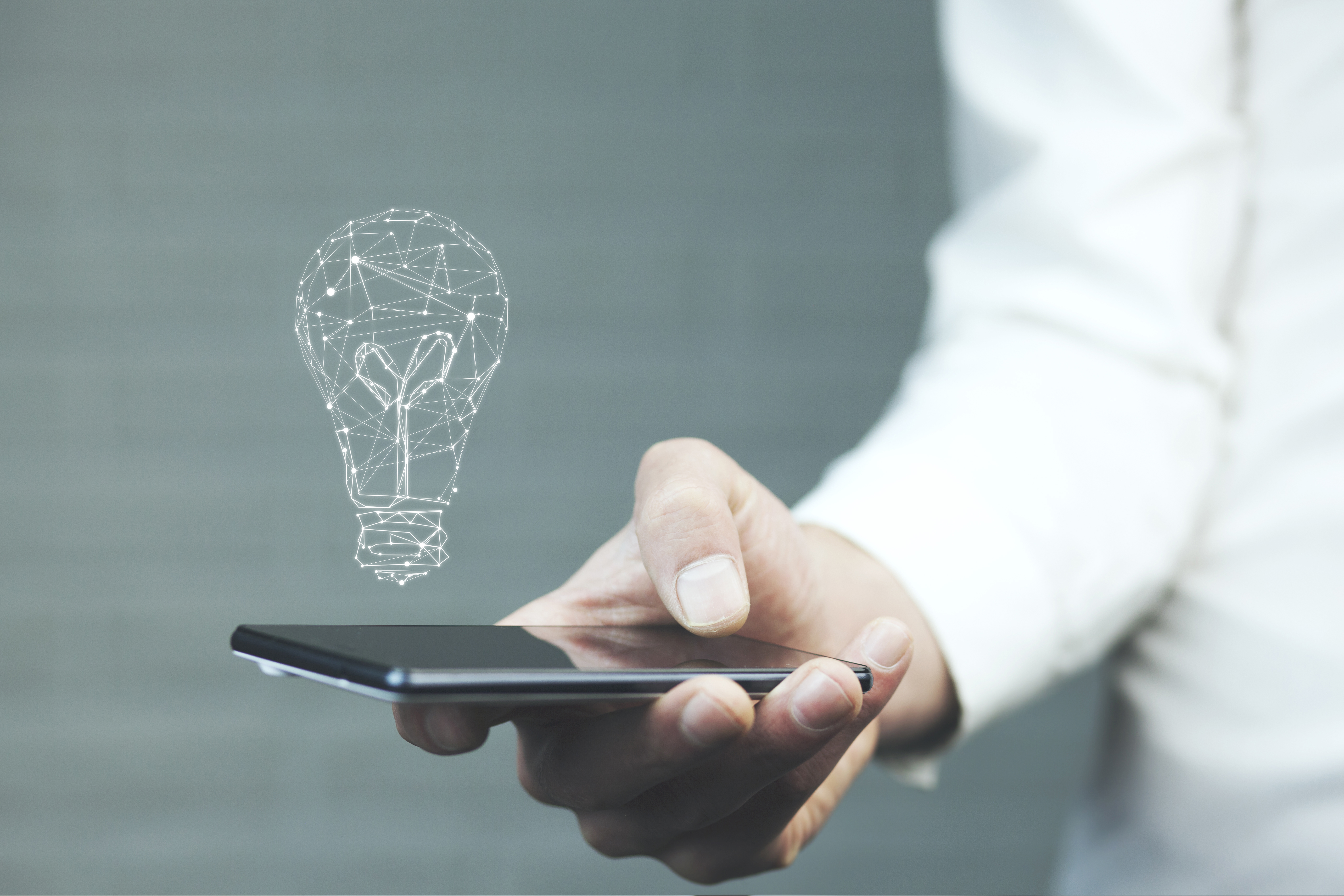 man holding phone with lightbulb graphic
