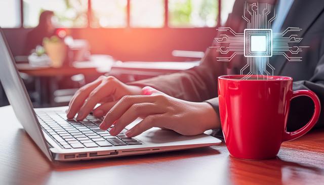 women typing on laptop